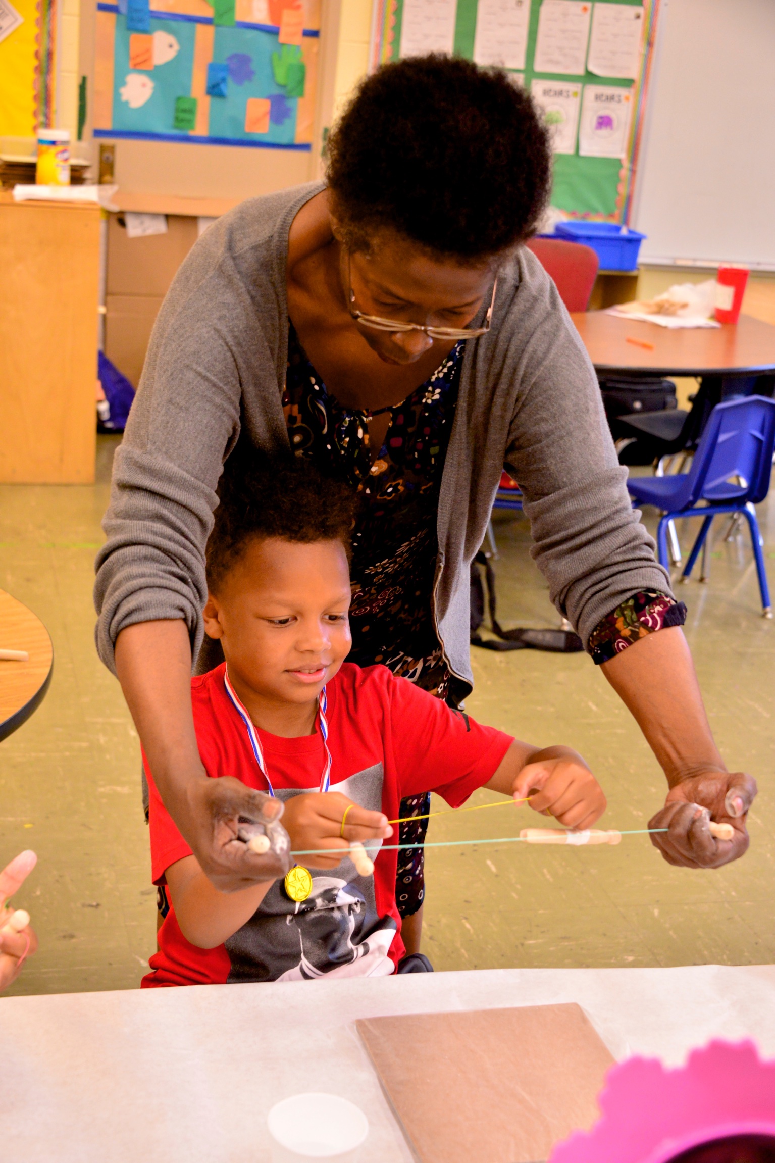 A female teacher working with a young boy