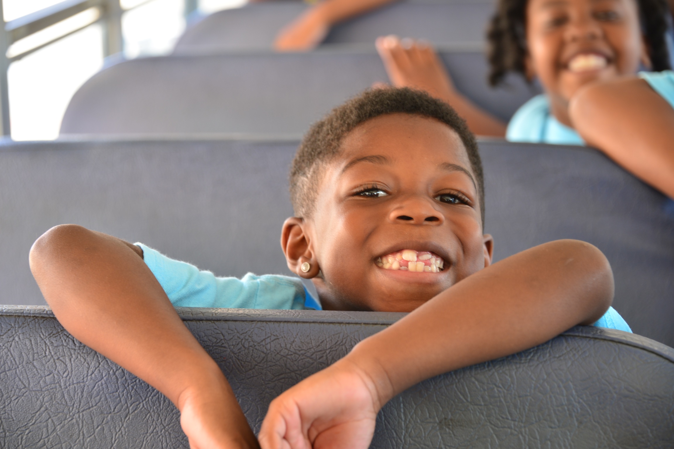 Smiling young boy on a school bus